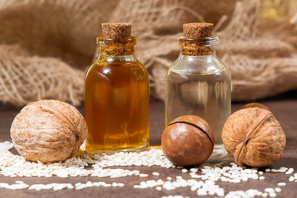 cosmetic oil from nuts walnuts, macadamia, sesame. still life, retro style, healthy foods, diet