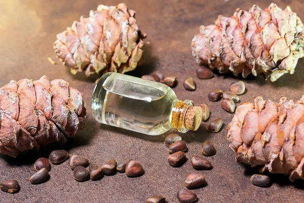 Pine nut oil on a brown background is traditionally used in the treatment of skin diseases. This is an excellent tool for healing wounds, cuts and burns.