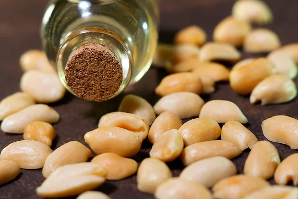 Peanut oil on a brown background is used in folk medicine, cosmetology, as well as for cooking various dishes