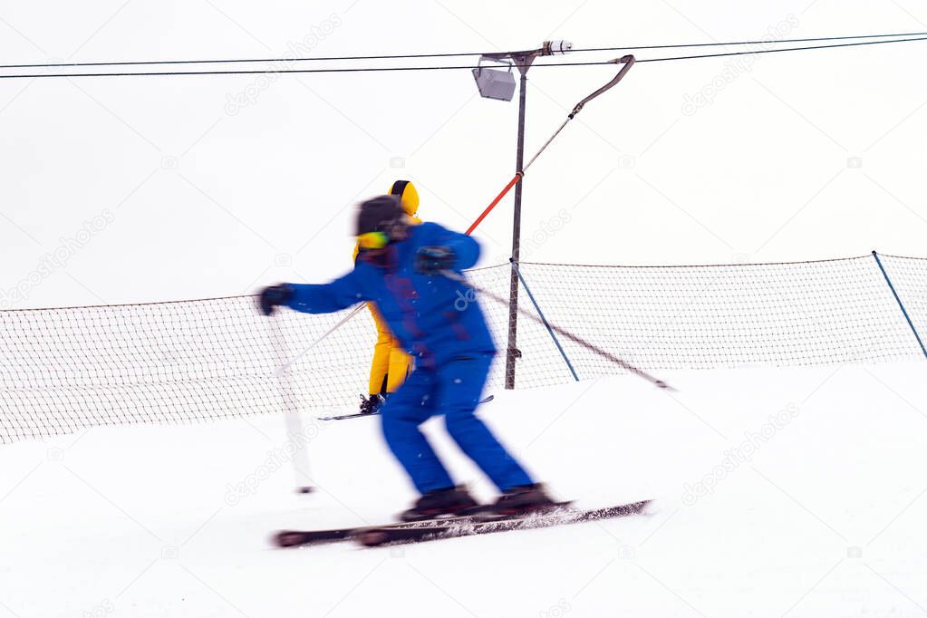 Skier quickly goes down the slope. Fuzziness