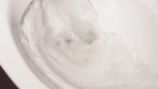 Flushes the water in the toilet. hygiene of the toilet room. water pours — Stock Video