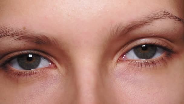 Szare, brązowe oczy, heterochromia sektora, patrząc w kamerę. Portret młodej kobiety, nastolatka — Wideo stockowe