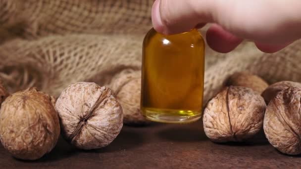 Cosmetic oil from nuts walnuts, macadamia, sesame. still life, retro style, healthy foods, diet — Stok video