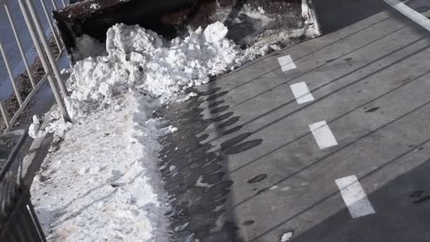 Cleaning snow snow thrower. Removing snow with the plow. Close up of iron snowplow pushing a lot of snow away. cleaning the city from snow, cleaning asphalt — Wideo stockowe