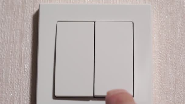 Hand turning on and off a light switch in a house — 图库视频影像