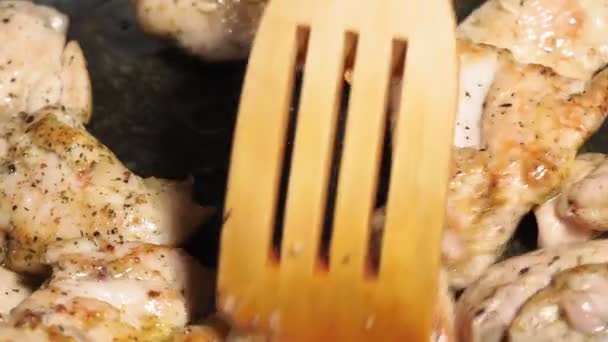 Pieces of chicken fillet are slowly fried in an open pan close-up. food preparation — Stock Video