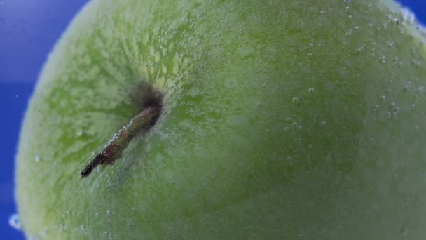 Appel in groen met water. sappig rijp fruit in water, onder water met belletjes macro foto — Stockvideo