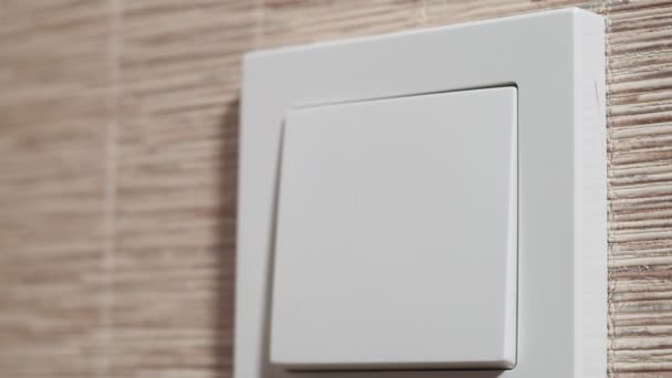 Light is Off-Male hand close-up switch off a button on a light wall, front view — Stock Video