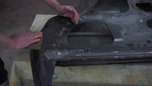 Automechanik používá, automobil, odstraňuje starou barvu. Manuální práce. příprava na lakování auta. — Stock video