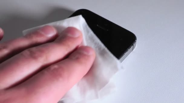Man cleaning smartphone screen with alcohol or sanitizer. Concept of Cleaning dirty screen phone for disease prevention from bacteria. sanitizing coronavirus prevention — Stock Video