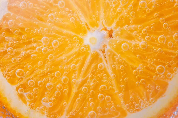 close-up image of orange fruit, background in water, under water. background, texture