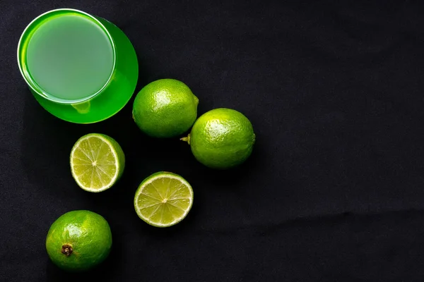 Tarragon lemonade, lime slice on a black background. the view from the top, place for text, Copy space.