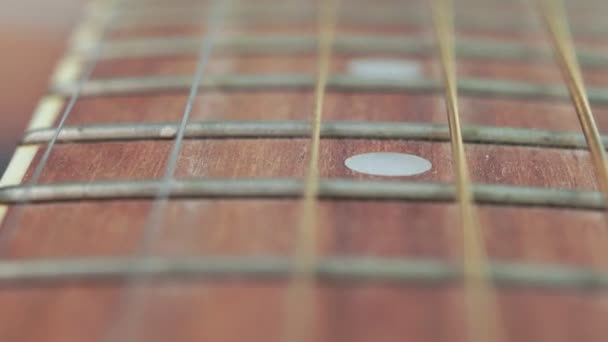 Acoustic guitar strings close up macro selective focus — Stock Video