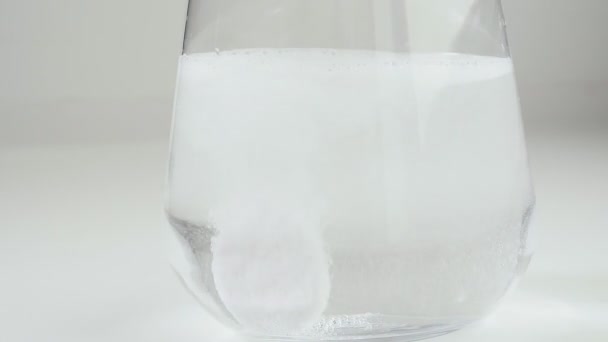 Acetylsalicylsyra koncept med brusande dryck tablett i vatten med tablett — Stockvideo
