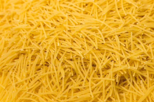 Droog vermicelli pasta klaar om te koken. sluit af met kopieerruimte. Voedselfoto. — Stockfoto