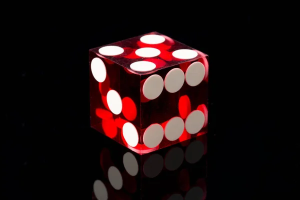 Red dices on a black background — Stock Photo, Image