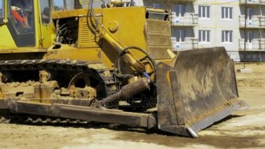 Sarı buldozer hareket. Kentin konut bir çok daire kompleksi inşaatı. İnşaat. Stok video görüntüleri.