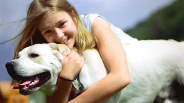 A teenage girl is playing with her favorite dog in the park. He is a devoted friend of man. — Stock Video