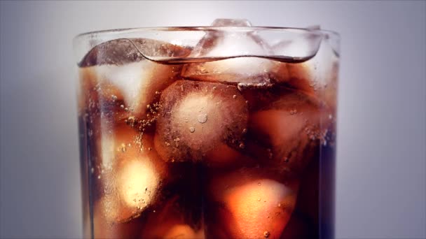 Cola con fondo de cubitos de hielo. Cola con hielo y burbujas en vidrio. Primer plano de la soda. Fondo alimenticio. Stock de imágenes de vídeo Full HD 4K — Vídeos de Stock