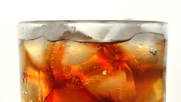 Cola with ice cubes background. Cola with Ice and bubbles in glass. Soda closeup. Food background. Stock full HD video footage 4K — Stock Video