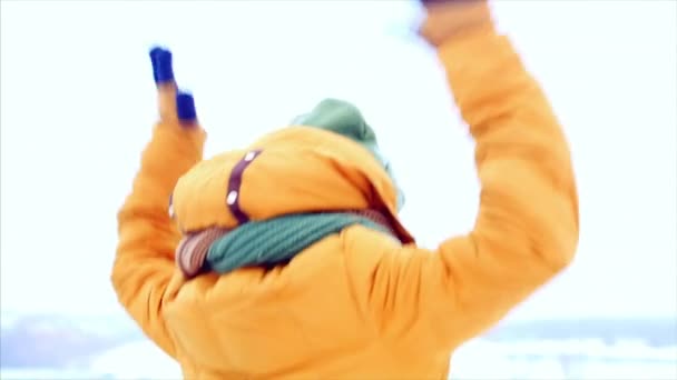 Happy young teenage girl raising her hands up enjoying a victory outdoors, close-up looks at the camera, smiling with happiness. Victory of a young happy beautiful model girl outdoors. — Stock Video