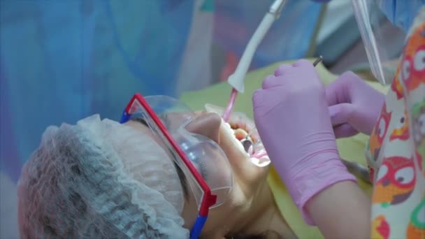 女性歯科医クリニックで女性患者に歯を治療します.仕事中の女性の専門医の組織学者。コンセプト歯科検診. — ストック動画