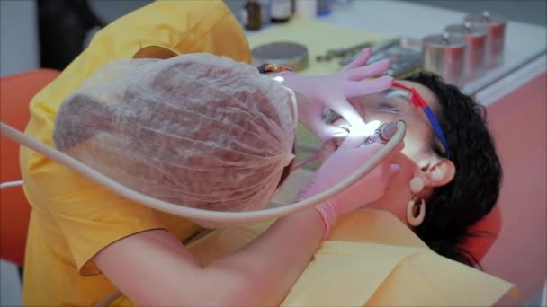 Mujer dentista tratando dientes a mujer paciente en clínica. Doctora Profesional Estomatóloga en el Trabajo. Concepto Dental Check Up. — Vídeos de Stock