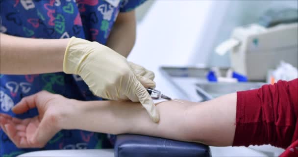 Detailní záběr na vakcínu podá sestra pacientovi lék intravenózně. Lékař aplikuje nebo odebere krev z žíly. — Stock video