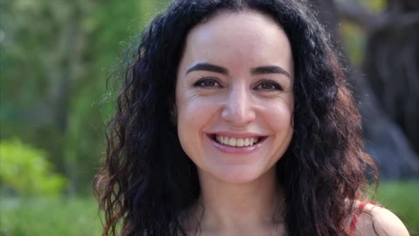 Portrait European Young Girl or Woman Cute or Cheerful Girl Brunette on the Street Looking in the Camera, Blowing Wind Hair the Wind , Slow Motion. — Stock Video