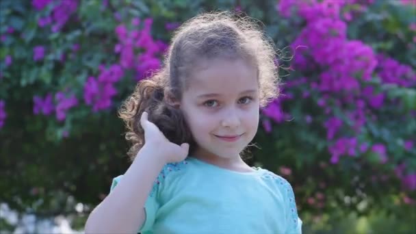 Portrait Cute Beautiful Little Girl or Child smilling on the Sunset in City Park . Stock Footage. — 비디오