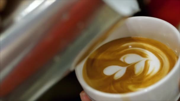 Making freshly ground coffee, Barista making Latte Art pouring milk into a mug while making a beautiful drawing, which makes the coffee even more desirable. Professional barista. — 图库视频影像