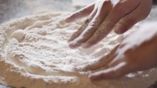 Cooking method, Italian makes real Italian pizza from dough with fingers, placing pizza in a wood-burning pizza oven using a pizza peel. Real pepperoni pizza, — Stock Video