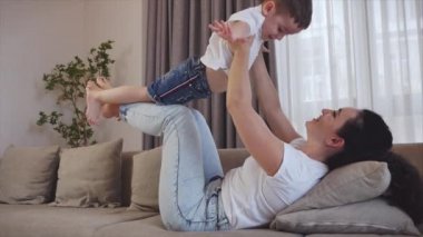 Mutlu sağlıklı bir aile, genç bir anne ve güzel bir oğul banyoda dişlerini fırçalıyor aynaya bakıyor birlikte gülümsüyor sağlık hizmetlerinin tadını çıkarıyorlar..
