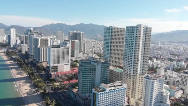 Luchtdrones hebben een prachtig uitzicht over de stad vanuit een vogelperspectief met wolkenkrabbers of hoge gebouwen tegen de achtergrond van een prachtige blauwe zee. 4K. — Stockvideo