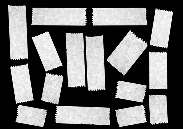 Fitas brancas e adesivos em fundo preto, elementos para ideias de designers — Fotografia de Stock