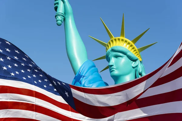 Big doll like Statue of Liberty and flag of the USA — Stock Photo, Image