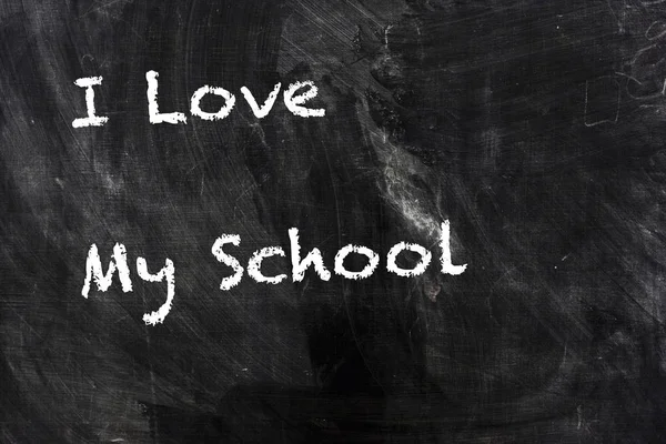 I love my SCHOOL text by chalk on school blackboard — стоковое фото