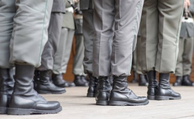 Row of soldiers legs dressed in special Austrian military shoes clipart