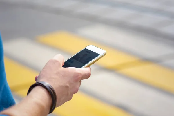 Man using a cellular phone in the city