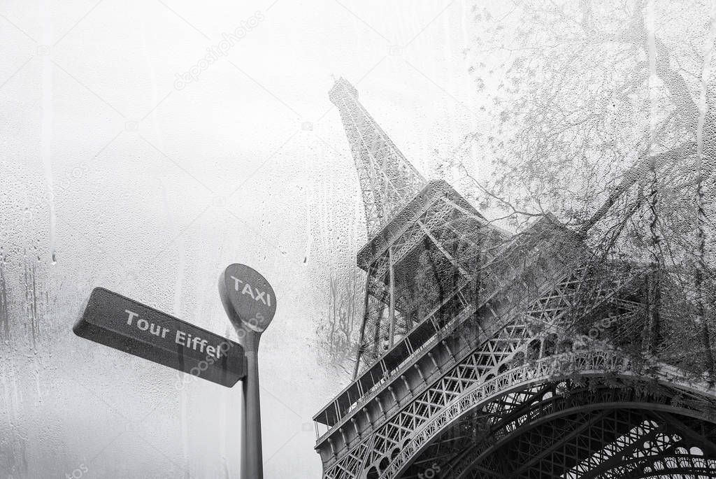 Eiffel tower through the window during the heavy rain in Paris