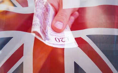 20 pound Not bir el ve Union Jack bayrak, İngiltere'de ekonomi durum hakkında kavramsal resim close-up