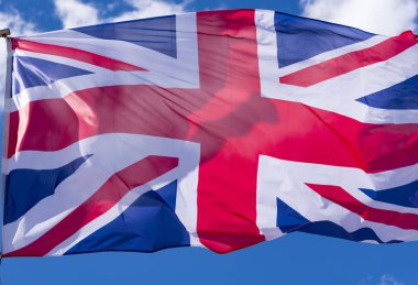 İngiliz bayrak mavi gökyüzü karşı rüzgarda sallayarak