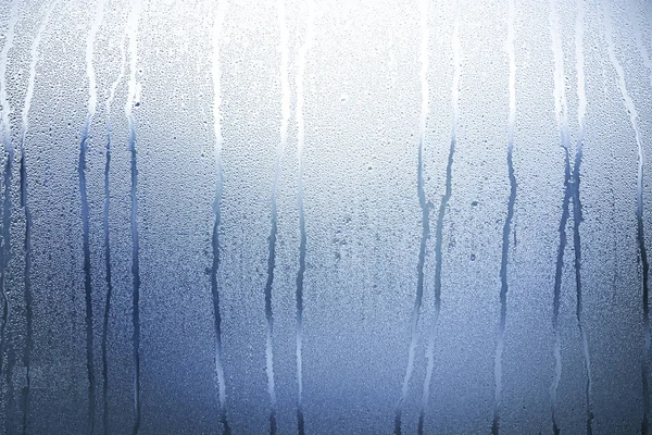 Blue Glass with Condensate, Window with Steam and Water as Background or Texture