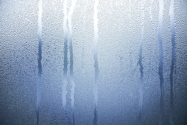 Blue Glass with Condensate, Window with Steam and Water as Background or Texture
