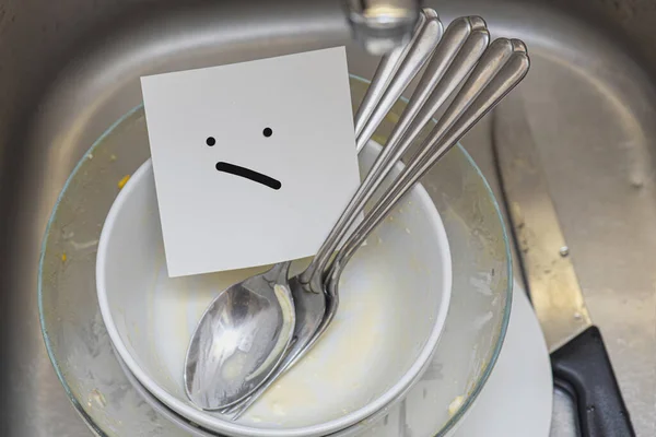 Some Dirty Dishes Spoons Knife Iron Sink Paper Sad Face — Stock Photo, Image