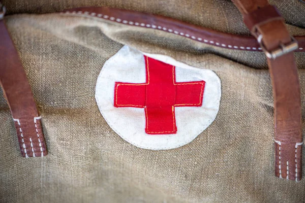 Close-up vintage military bag with a red cross. Soviet bag for medicines. Old bag for the military. The Second World War
