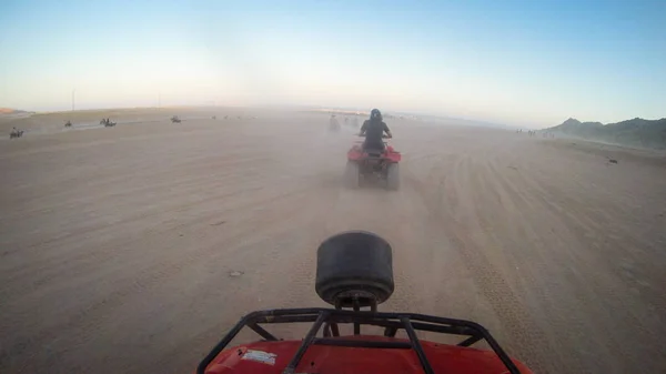 Las niñas conducen quad bike.Desert en Egipto. Sharm el Sheikh. Arena y una —  Fotos de Stock