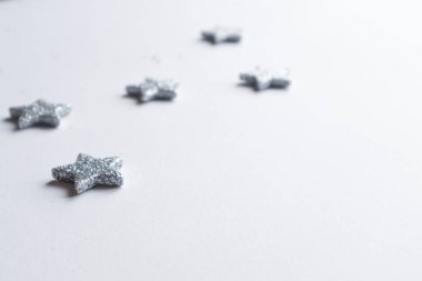 Noel çerçevesi gümüş yıldızları beyaz arka planda yaptı. Kış konsepti Düz konum, üst görünüm, kopyalama alanı. Noel kompozisyonu. 