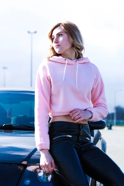 Girl in pink crop top. Stylish streetwear for teens. Shooting ne