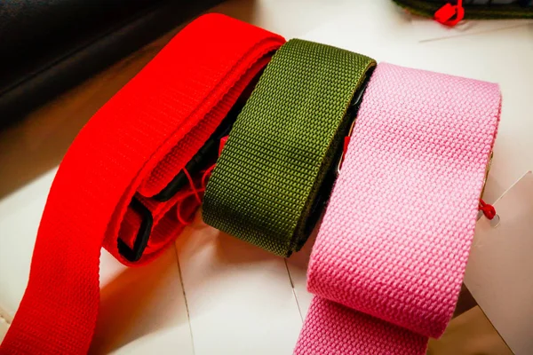 Stylish colored belts. Fabric. Pink, red and khaki. Fashion and